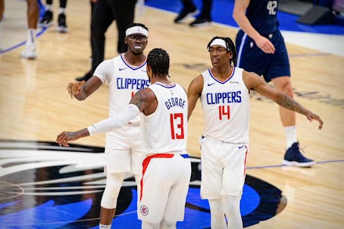 May 28, 2021; Dallas, Texas, USA; LA Clippers guard Paul George (13) and guard Terance Mann (14) celebrate during the second quarter against the Dallas Mavericks in game three in the first round of the 2021 NBA Playoffs at American Airlines Center. Mandatory Credit: Jerome Miron-USA TODAY Sports